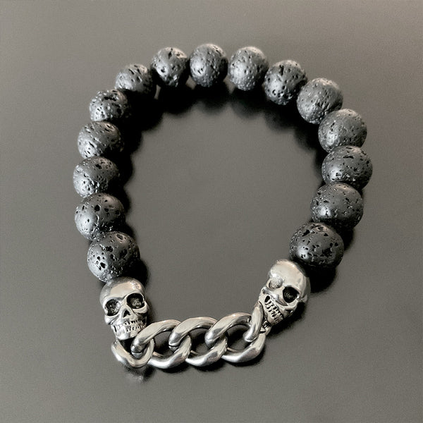 Pulsera de pepas negras con calaveras en acero