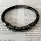 Pulsera negra con eslabón de acero